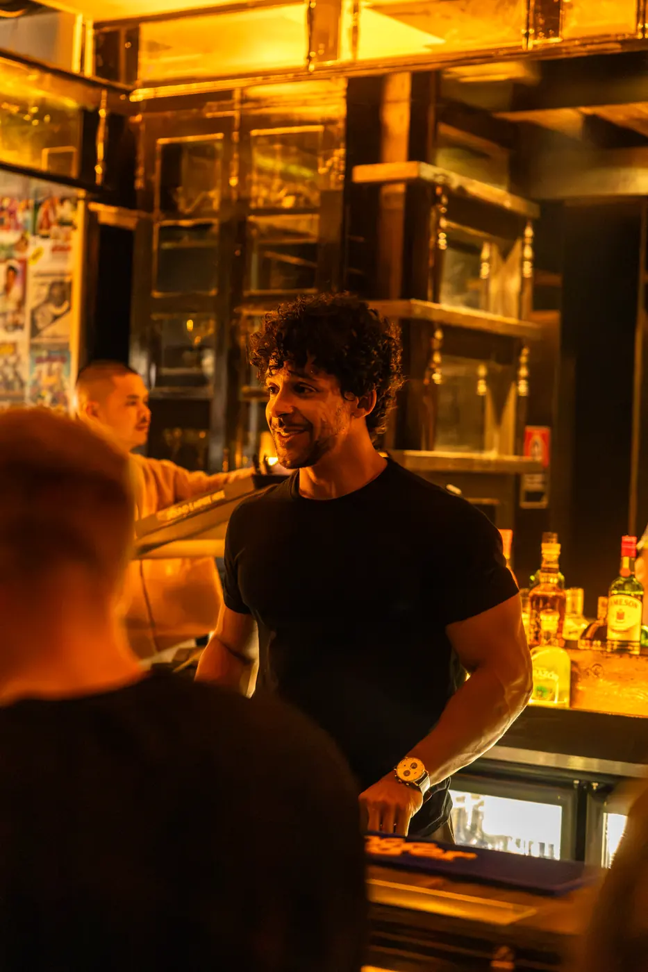 A smiling bartender behind the Soi Fire bar