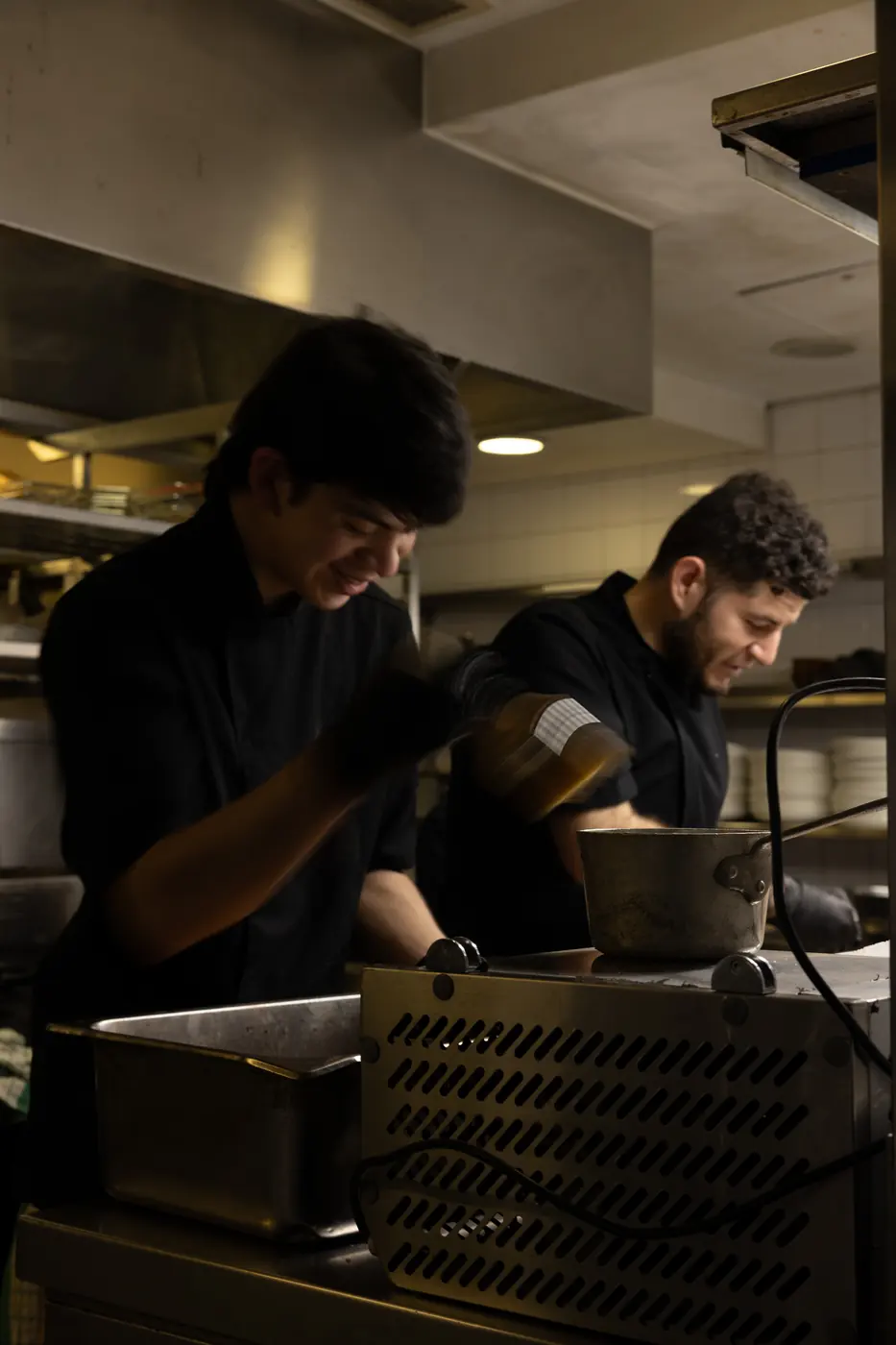 Two chefs working the kitchen at Soi Fire